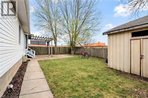 Fenced backyard with a shed and a patio area - 65 Thistlemoor Drive, Caledonia, ON - Outdoor
