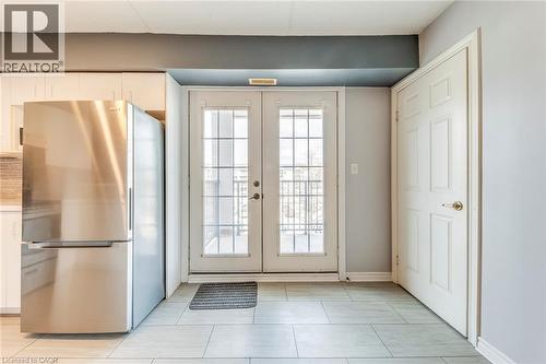 Doorway to outside with tile patterned floors and french doors - 1411 Walker'S Line Unit# 302, Burlington, ON - Indoor Photo Showing Other Room