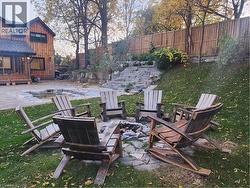 Fenced backyard with a patio area, an outdoor fire pit, and a gazebo - 