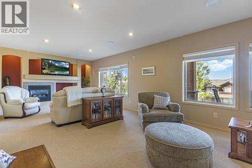Lower level family room - 610 Arrowleaf Lane, Kelowna, BC - Indoor Photo Showing Living Room With Fireplace