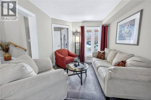 Living room featuring wood finished floors and a textured ceiling - 3753 Densbury Drive, Mississauga, ON - Indoor Photo Showing Living Room