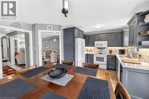 Kitchen featuring gray cabinets, white appliances, decorative backsplash, and light stone counters - 3753 Densbury Drive, Mississauga, ON - Indoor Photo Showing Kitchen