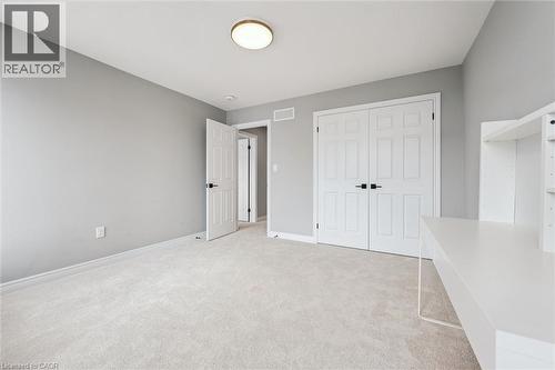Unfurnished bedroom featuring light carpet and a closet - 628 Florencedale Crescent, Kitchener, ON - Indoor Photo Showing Other Room