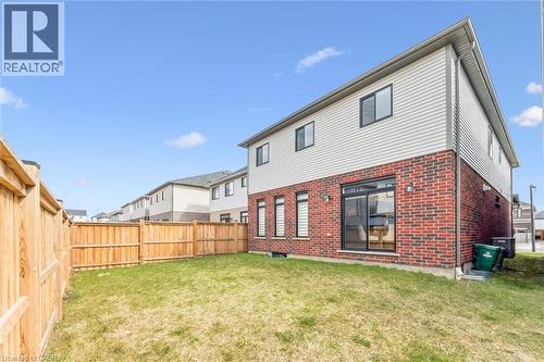 Back of property with brick siding, a fenced backyard, and a residential view - 628 Florencedale Crescent, Kitchener, ON - Outdoor With Exterior