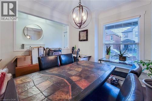 Dining area featuring a chandelier - 97 Keith Street, Hamilton, ON - Indoor Photo Showing Dining Room