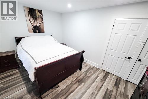 Bedroom with light wood-type flooring and recessed lighting - 97 Keith Street, Hamilton, ON - Indoor