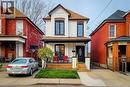 View of front facade featuring a porch, a shingled roof, and brick siding - 97 Keith Street, Hamilton, ON  - Outdoor 