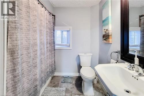Bathroom with a textured ceiling and a shower with shower curtain - 97 Keith Street, Hamilton, ON - Indoor Photo Showing Bathroom