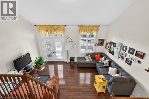 Living area featuring dark wood-style floors and french doors - 97 Sirente Drive, Hamilton, ON - Indoor Photo Showing Living Room