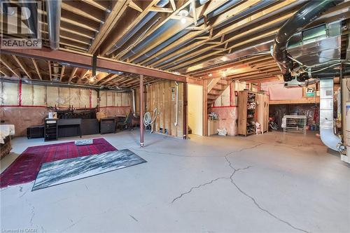 Unfinished basement featuring water heater - 97 Sirente Drive, Hamilton, ON - Indoor Photo Showing Basement