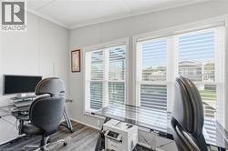 Office space with crown molding and wood finished floors - 