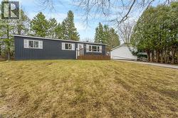 View of front facade with a deck and a front yard - 