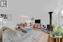 Living area with light wood-style floors and a wood stove - 