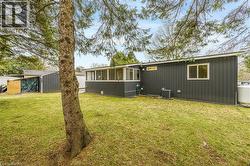 View of front of house featuring a sunroom and a front lawn - 