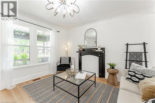 Bright & spacious living room with new lighting overlooks the front porch. - 15 Barnesdale Avenue N, Hamilton, ON - Indoor
