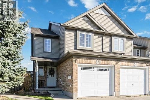 Traditional-style house featuring a garage, driveway, and a porch - 27 Red Clover Crescent, Kitchener, ON - Outdoor With Facade