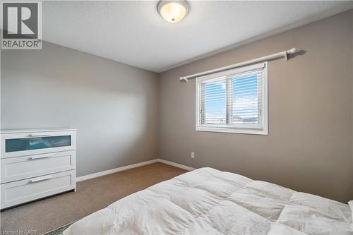 Carpeted bedroom with baseboards and a textured ceiling - 27 Red Clover Crescent, Kitchener, ON - Indoor Photo Showing Bedroom