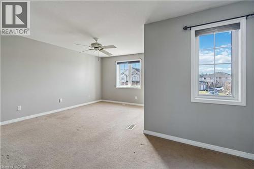 Empty room featuring light colored carpet and ceiling fan - 27 Red Clover Crescent, Kitchener, ON - Indoor Photo Showing Other Room
