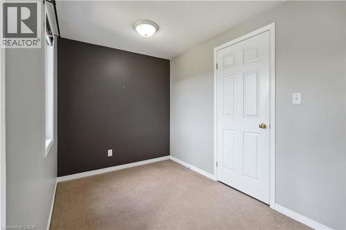Empty room with light carpet and baseboards - 27 Red Clover Crescent, Kitchener, ON - Indoor Photo Showing Other Room