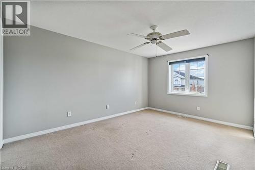 Unfurnished room featuring light carpet and a ceiling fan - 27 Red Clover Crescent, Kitchener, ON - Indoor Photo Showing Other Room