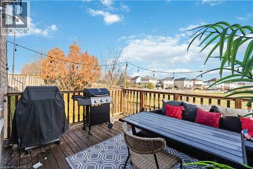 Deck with grilling area, outdoor dining area, and a residential view - 27 Red Clover Crescent, Kitchener, ON - Outdoor With Deck Patio Veranda