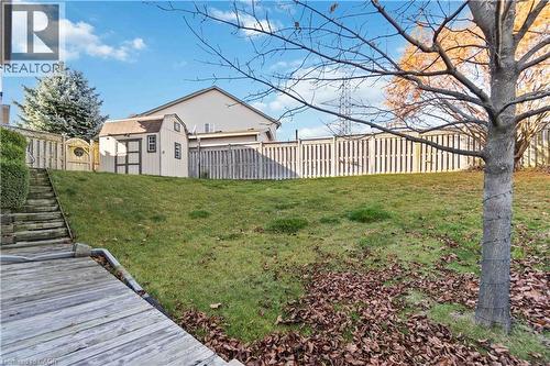 Fenced backyard featuring a storage shed - 27 Red Clover Crescent, Kitchener, ON - Outdoor