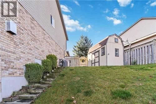 Fenced backyard with a shed and stairs - 27 Red Clover Crescent, Kitchener, ON - Outdoor
