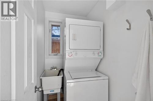 Laundry room with stacked washing machine and dryer - 216 Robert Street, Hamilton, ON - Indoor Photo Showing Laundry Room