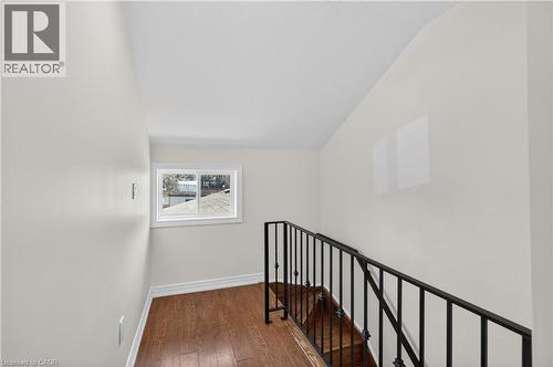 Stairs with wood-type flooring and baseboards - 216 Robert Street, Hamilton, ON - Indoor Photo Showing Other Room