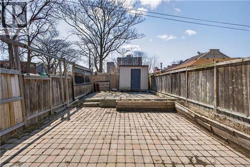 Fenced backyard with a storage shed and a patio - 216 Robert Street, Hamilton, ON - Outdoor With Deck Patio Veranda