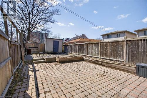 Fenced backyard featuring a storage unit and a patio - 216 Robert Street, Hamilton, ON - Outdoor With Deck Patio Veranda