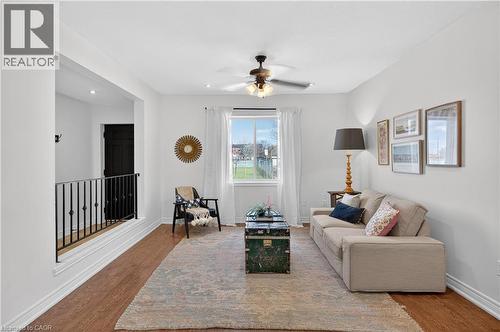 Living room with a ceiling fan and wood finished floors - 216 Robert Street, Hamilton, ON - Indoor
