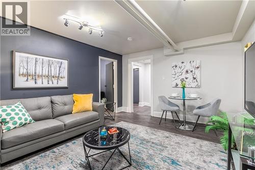 Living area featuring wood finished floors and baseboards - 14 Duke Street, Hamilton, ON - Indoor Photo Showing Living Room