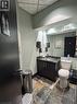 Half bathroom featuring vanity, stone tile flooring, and a paneled ceiling - 14 Duke Street, Hamilton, ON  - Indoor 