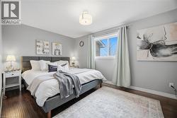 Bedroom with dark wood finished floors and baseboards - 