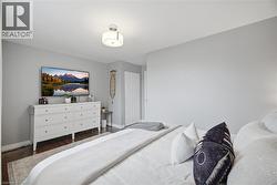 Bedroom with wood finished floors and baseboards - 