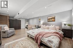 Bedroom with light wood-style flooring and recessed lighting - 