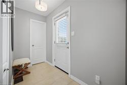 Doorway featuring baseboards and wood finished floors - 