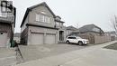 View of front of home featuring brick siding, an attached garage, driveway, and a residential view - 110 Rivertrail Avenue, Kitchener, ON  - Outdoor 