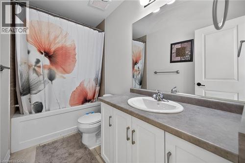 Bathroom featuring vanity, shower / tub combo with curtain, and light tile patterned floors - 80 Severino Circle, Smithville, ON - Indoor Photo Showing Bathroom