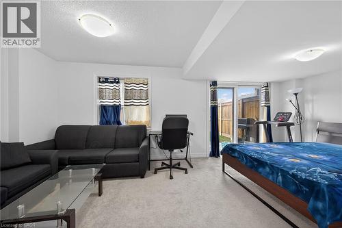 Bedroom with light carpet, access to exterior, and a textured ceiling - 80 Severino Circle, Smithville, ON - Indoor