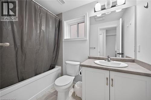 Full bath with vanity, shower / tub combo with curtain, and light tile patterned floors - 80 Severino Circle, Smithville, ON - Indoor Photo Showing Bathroom