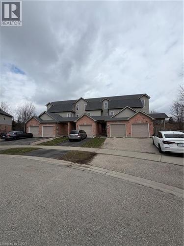 Traditional-style house featuring brick siding, driveway, and a residential view - 45 Brookfield Crescent, Kitchener, ON - Outdoor