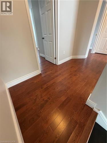 Unfurnished room with baseboards and dark wood-style flooring - 45 Brookfield Crescent, Kitchener, ON - Indoor Photo Showing Other Room