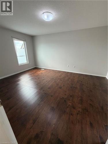 Unfurnished room featuring dark wood finished floors and a textured ceiling - 45 Brookfield Crescent, Kitchener, ON - Indoor Photo Showing Other Room