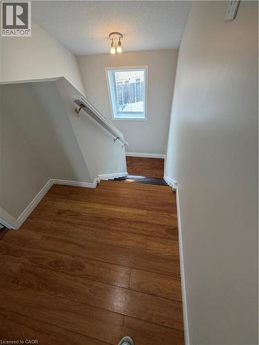 Stairs featuring wood finished floors and a textured ceiling - 45 Brookfield Crescent, Kitchener, ON - Indoor Photo Showing Other Room