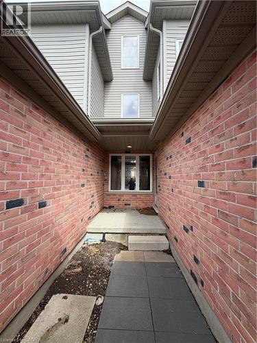 Property entrance with brick siding - 45 Brookfield Crescent, Kitchener, ON - Outdoor With Exterior