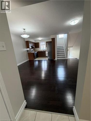 Unfurnished living room featuring baseboards and dark wood finished floors - 45 Brookfield Crescent, Kitchener, ON - Indoor Photo Showing Other Room