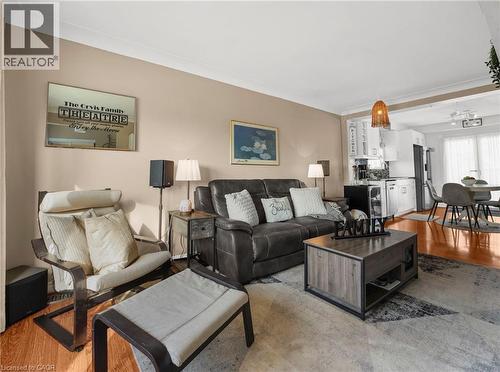 Living room with light wood-style floors and crown molding - 420 Waverly Street, Hamilton, ON - Indoor Photo Showing Living Room