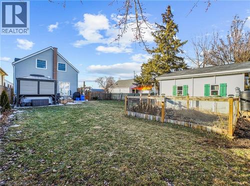 Fenced backyard featuring a garden and shed with hydro - 420 Waverly Street, Hamilton, ON - Outdoor